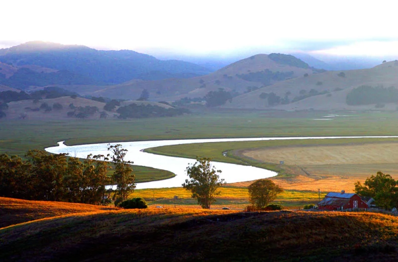The Petaluma River winding through open land outside town